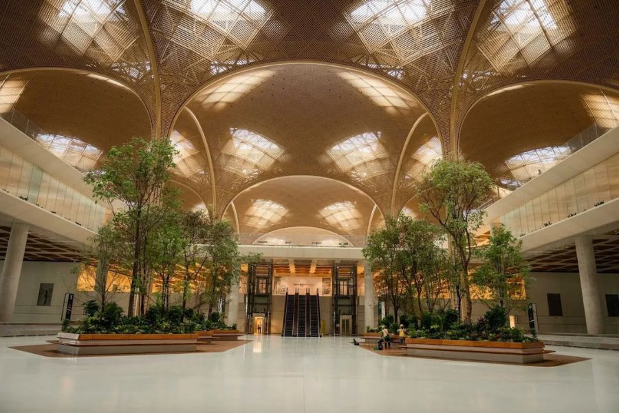 Techo International Airport Cambodia grand atrium with indoor trees and lotus-pattern ceiling